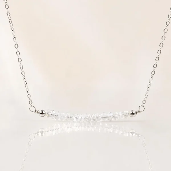 Moonstone Bar Necklace displayed on a mannequin with a minimalist sterling silver chain and faceted moonstone beads