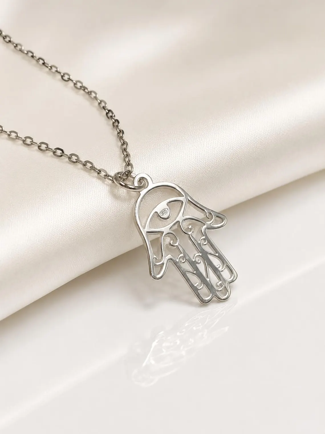 Close-up of sterling silver Hamsa pendant showing minimalist 925 silver detailing