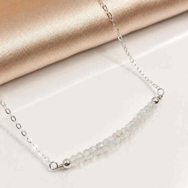 Close-up of faceted moonstone bar pendant on a delicate sterling silver chain