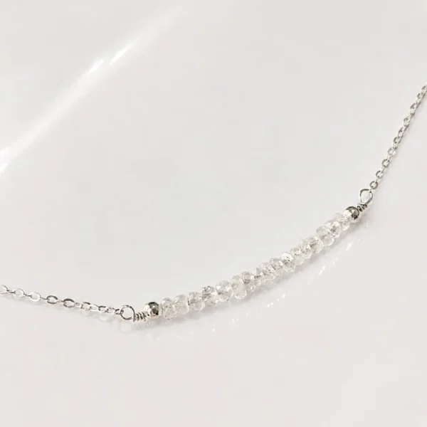 Close-up of faceted moonstone bar pendant on a delicate sterling silver chain