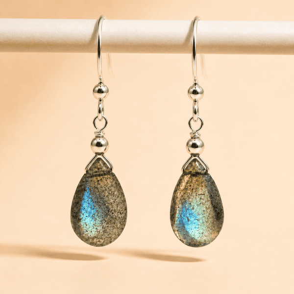 Close-up of natural labradorite gemstone with grey-blue iridescent flash in sterling silver setting