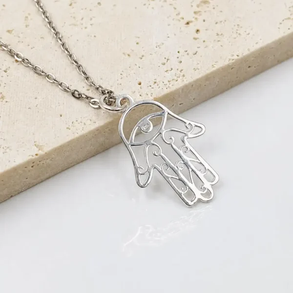 Close-up of sterling silver Hamsa pendant showing minimalist 925 silver detailing