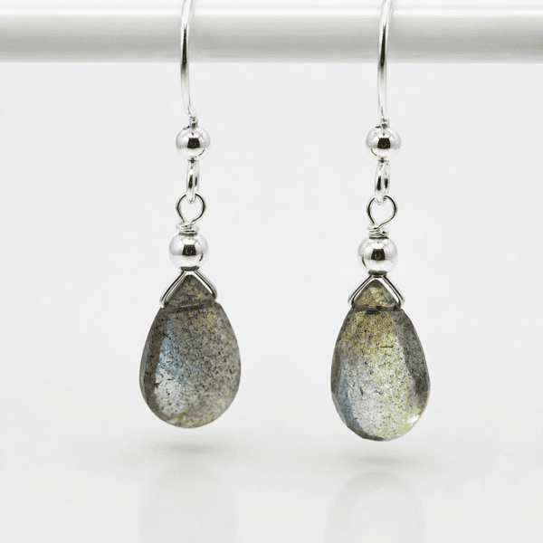 Close-up of natural labradorite gemstone with grey-blue iridescent flash in sterling silver setting