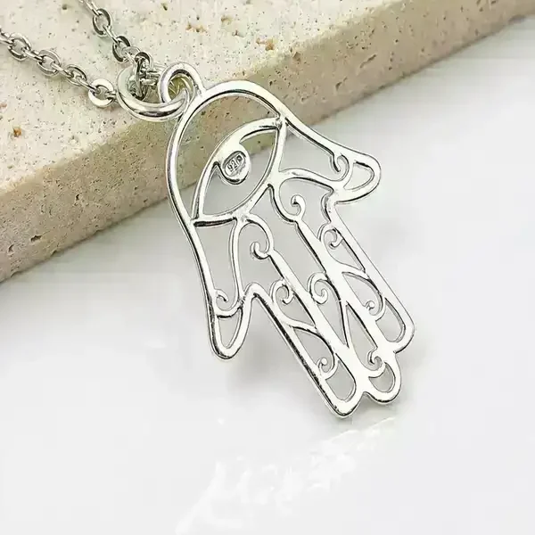 Close-up of sterling silver Hamsa pendant showing minimalist 925 silver detailing