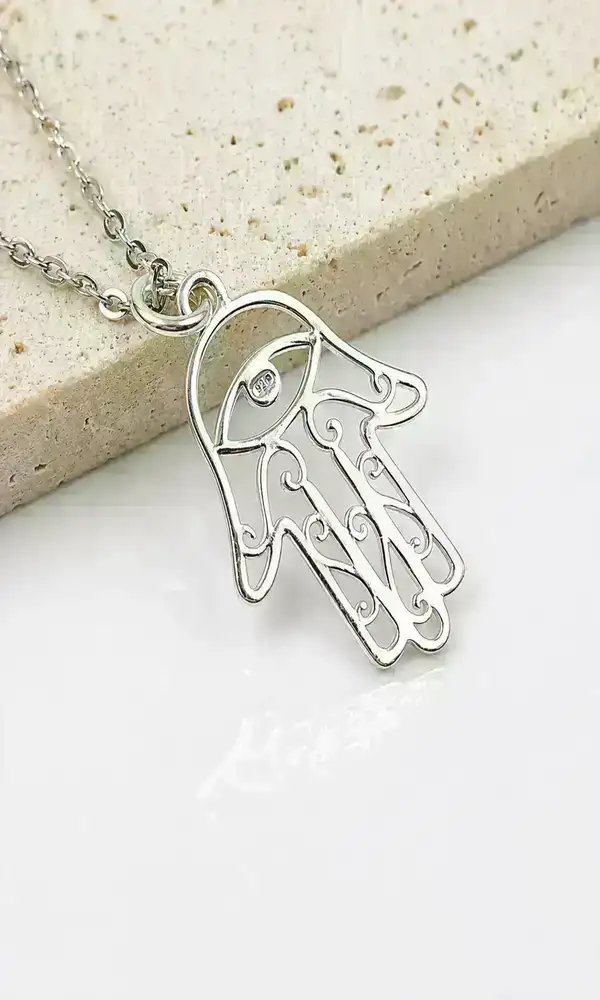 Close-up of sterling silver Hamsa pendant showing minimalist 925 silver detailing