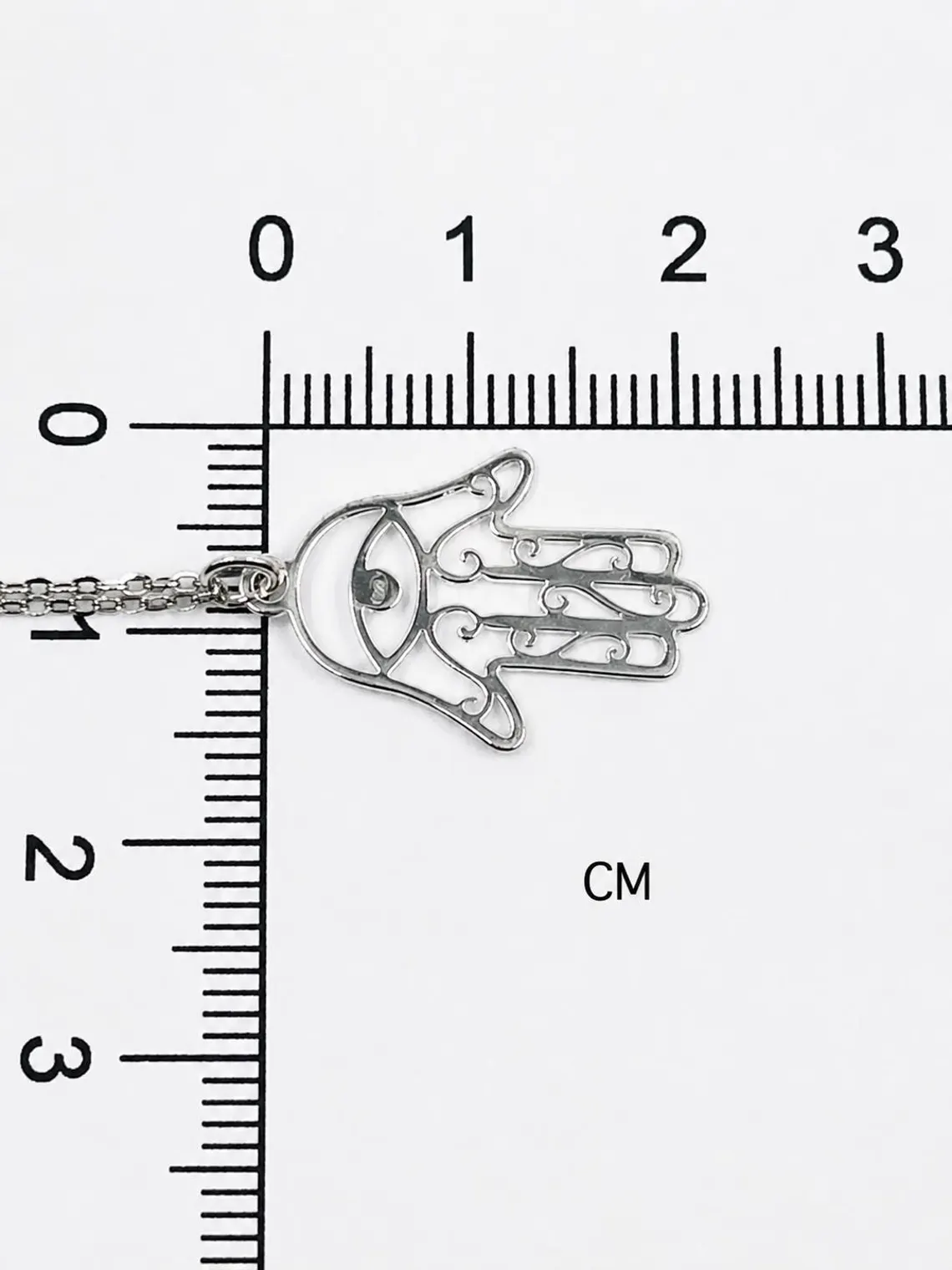 Close-up of sterling silver Hamsa pendant showing minimalist 925 silver detailing